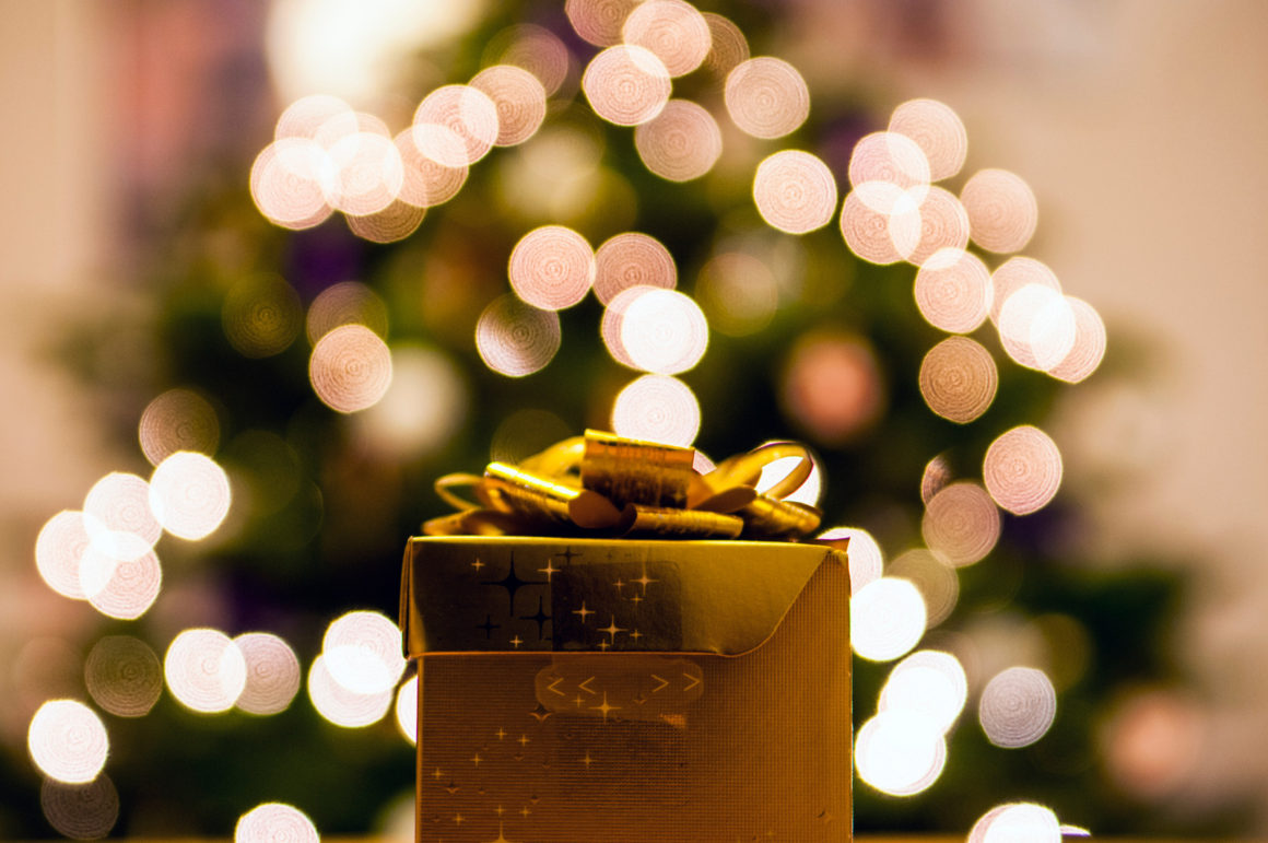 Gold-colored Gift Box With White Bokeh Background